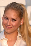 Anna Kournikova shows her long legs in black mini skirt and give a peek at her black bra under white blouse at Chanel 2008/09 Cruise Show in Miami